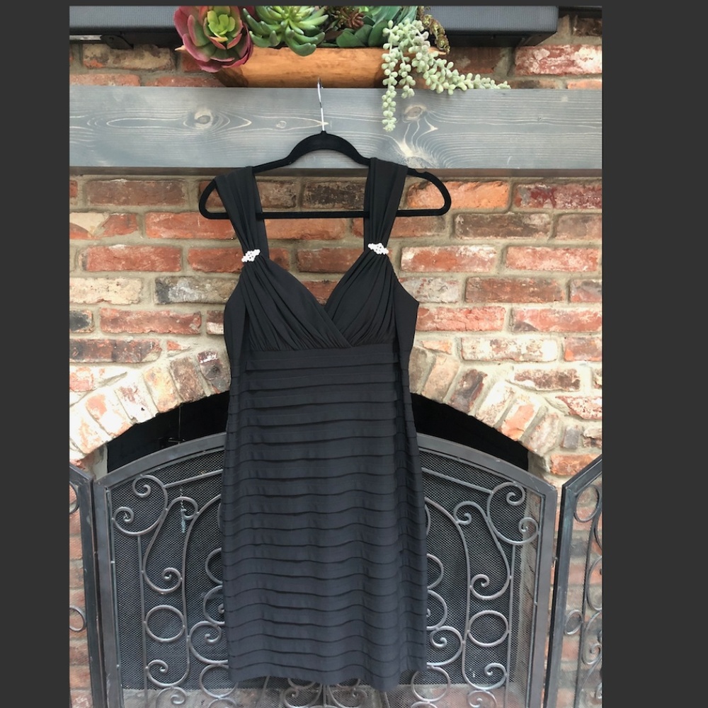 Short black gown with strap embellishments